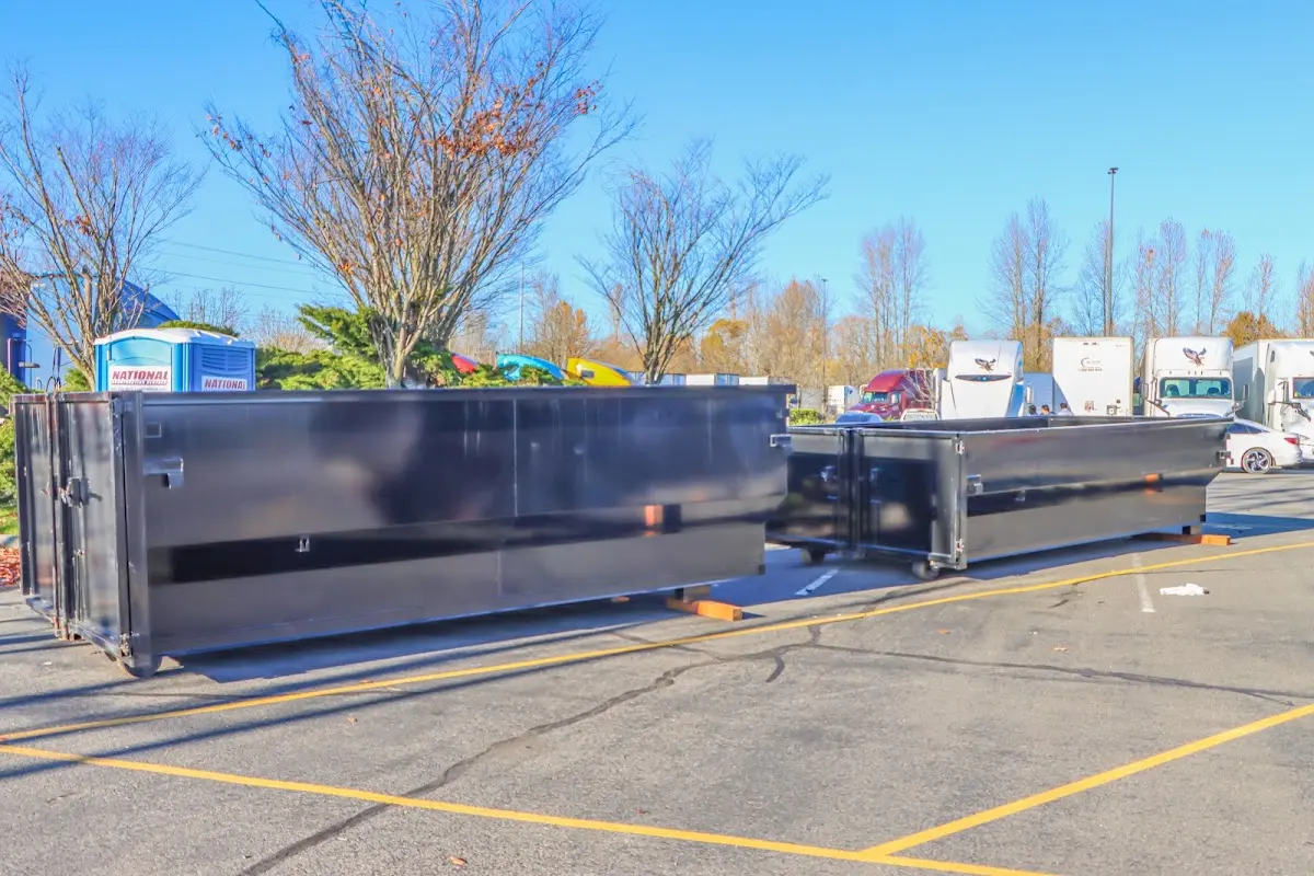 Professional dumpster rental service with roll-off container on residential driveway in Union